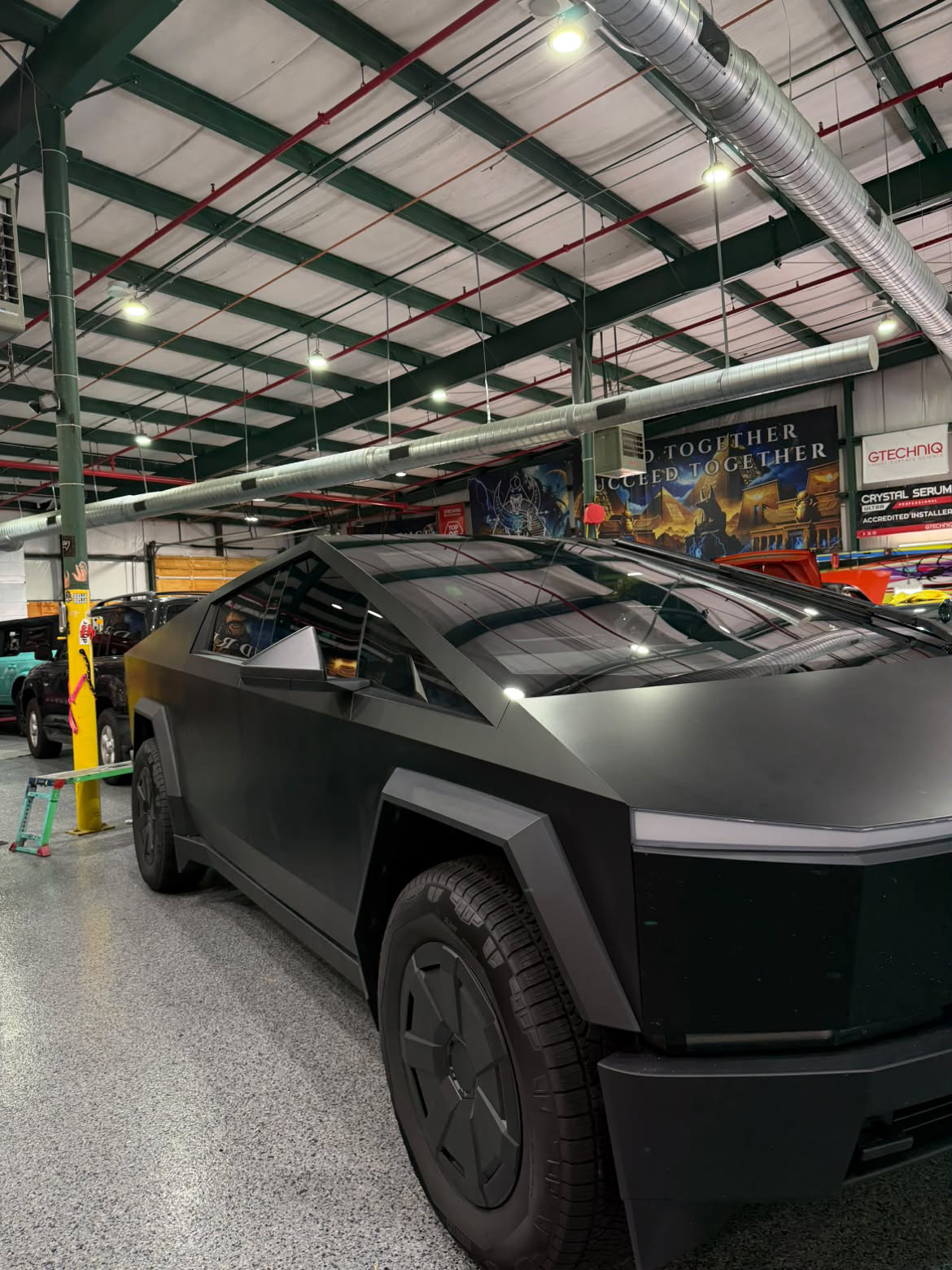 Matte black electric truck receiving specialty glass service