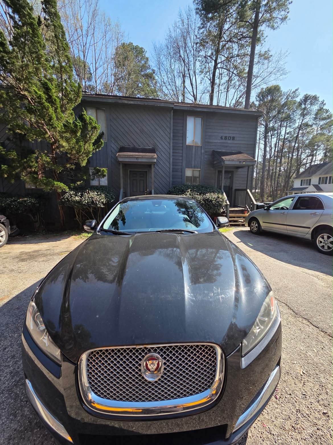 Black luxury sedan at a customer's home after a mobile windshield service
